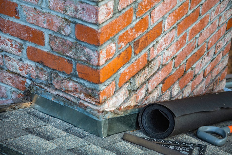 Roof flashing being replaced around a chimney on an Adelaide home — fresh lead flashing dressed into the brickwork